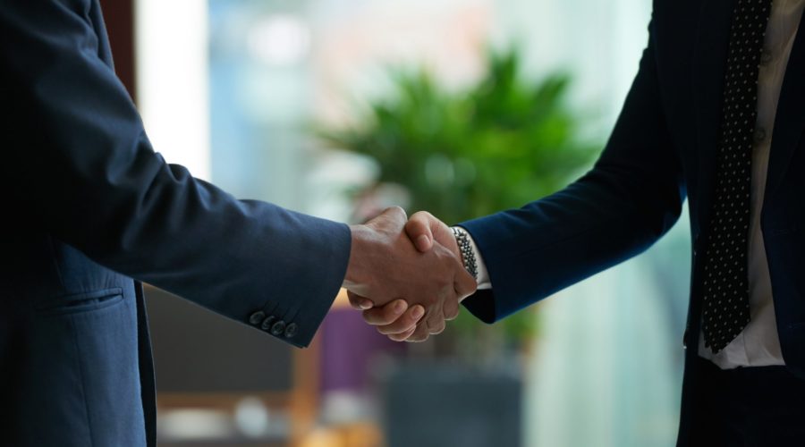 Business people shaking hands to confirm deal
